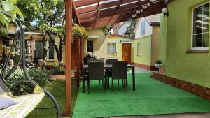 a patio with a table and chairs on a house at Dom wakacyjny u Mirka in Ustka