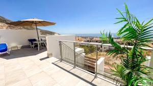 a balcony with a table and an umbrella at La Serena Mar, Benalmadena Pueblo, Luxury Apartment with Jacuzzi in Benalmádena