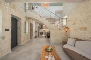 a living room with a couch and a table at Megalith Villas in Agia Marina Nea Kydonias