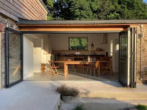 an extension of a house with a table and a kitchen at Home Farm - theundergroundstream in Churchstow