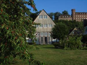 a large house with a tree in front of it at Fischerhaus Herstelle in Beverungen