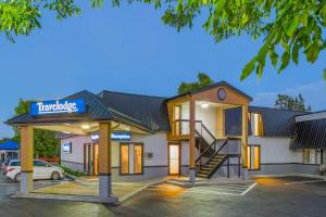 a hotel building with a sign that reads therapists at Travelodge by Wyndham Gananoque in Gananoque