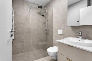 a bathroom with a shower and a toilet and a sink at Central Studio Apartment in Reykjavík