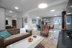 a living room with a couch and a table at Villa Marta in Sukošan