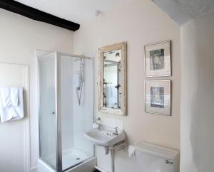 a white bathroom with a sink and a toilet at Black Lion Hotel in Little Walsingham