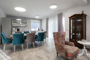 a living room with a table and chairs and a kitchen at Villa Marta in Sukošan