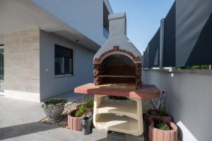 a brick oven on the side of a building at Villa Marta in Sukošan