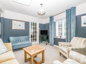 a living room with a couch and a table at Oxford House in Minehead