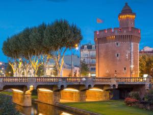 a castle and a bridge over a river at ibis budget Perpignan Centre in Perpignan