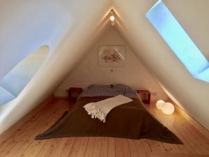 a bedroom with a bed in a attic at Backhaus 