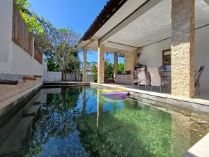 a house with a pool with a frisbee in it at Kanaan House in Nusa Dua