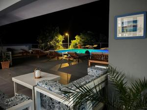 a patio with a swimming pool at night at Dela in Hvar