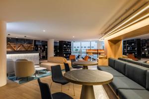 a library with couches and tables and chairs at Andaz Mexico City Condesa - A Concept by Hyatt in Mexico City