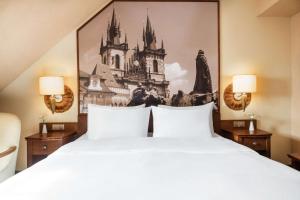 a bedroom with a bed with a painting on the wall at Lindner Hotel Prague Castle, part of JdV by Hyatt in Prague