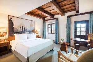 a hotel room with a bed and a desk at Lindner Hotel Prague Castle, part of JdV by Hyatt in Prague +41 photos