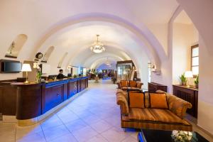 a lobby with a bar in a hotel at Lindner Hotel Prague Castle, part of JdV by Hyatt in Prague