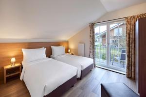 Postel nebo postele na pokoji v ubytování Lindner Hotel Nurburgring Ferienpark, part of JdV by Hyatt + 37 fotografií