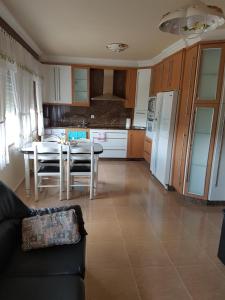 a living room with a table and a kitchen at Casa Camiño dos Faros in Sinde +13 photos