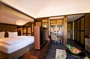 a hotel room with a bed and a desk at Lindner Hotel Mallorca Portals Nous, part of JdV by Hyatt in Portals Nous