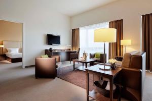 a large hotel room with a living room at Lindner Hotel Antwerp, part of JdV by Hyatt in Antwerp