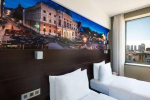 a hotel room with a large painting on the wall at Lindner Hotel Bratislava, part of JdV by Hyatt in Bratislava