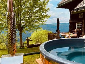 a jacuzzi tub in a backyard with a view at Ferienwohnung Hintereck in Gütenbach