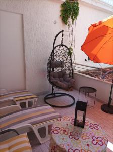 ein Zimmer mit einem Stuhl und einem orangenen Regenschirm in der Unterkunft Apartments Vodice Marica in Vodice