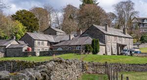 a group of houses with a stone wall at Thirlmere in Sawrey