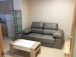 a living room with a couch and a coffee table at AP. FORCELLEDO in Posada de Llanes +8 photos