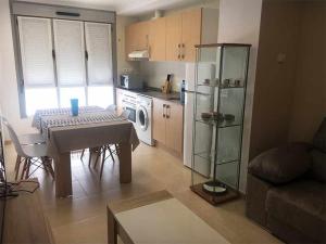 a living room with a table and a kitchen at AP. FORCELLEDO in Posada de Llanes