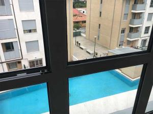 a view from a window of a swimming pool at AP. FORCELLEDO in Posada de Llanes