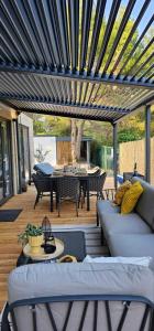 a patio with a blue pergola with a table and chairs at MH Holiday Dream - Morning Sun in Drage
