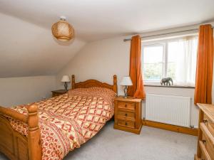 a bedroom with a bed and a window at Mossy Lodge in Shrewsbury