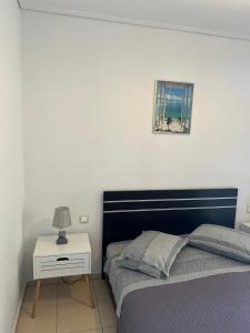 a bedroom with a bed and a picture on the wall at Luxury Studio Artemida in Artemida