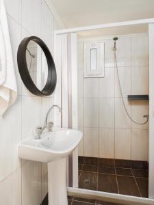 a bathroom with a sink and a shower at Divina Seaside Apartments by Estia in Gouves