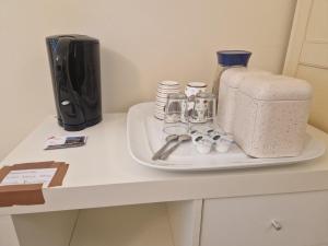 a counter with a coffee maker and cups on it at West Beck House in Darlington