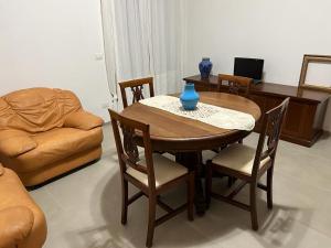 uma sala de estar com uma mesa e cadeiras e um sofá em La Vecchia Posta em Telti
