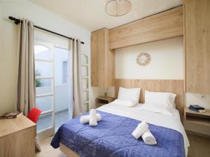 a bedroom with a bed with towels on it at Divina Seaside Apartments by Estia in Gouves