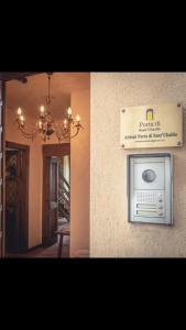 two pictures of a house with a sign on the wall at Umbrian cottage in Gubbio