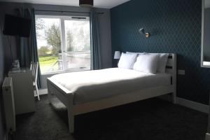 a bedroom with a bed with a window and a bed sidx sidx sidx at Lunan House in Arbroath