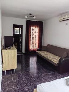 a living room with a couch and a television at Casa Alexandru in 2 Mai