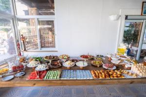 a table with many different types of food on it at Costa Bodrum City in Bodrum City