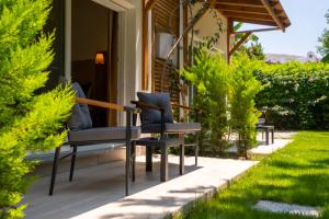 a pair of chairs sitting on the porch of a house at Costa Bodrum City in Bodrum City