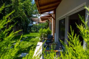 a garden with a chair in the grass at Costa Bodrum City in Bodrum City