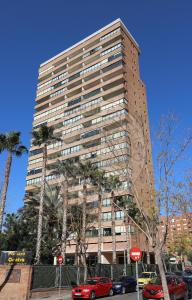 ein hohes Gebäude mit davor geparkt in der Unterkunft Apartamentos Paraíso Centro - BenidormParaíso in Benidorm