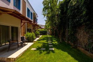 a garden with a lawn with a pathway at Costa Bodrum City in Bodrum City