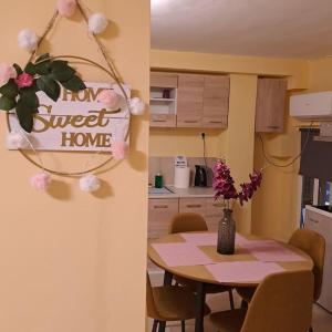 a kitchen and a table with a sign that reads turn sweet home at Zenia Home 1 Στην καρδιά της Πάτρας in Patra