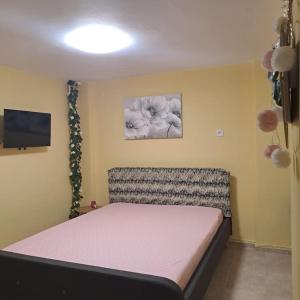 a bedroom with a bed and a television in it at Zenia Home 1 Στην καρδιά της Πάτρας in Patra