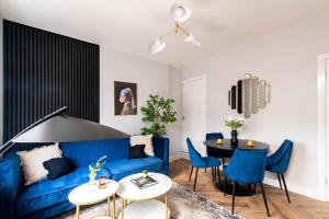 a living room with a blue couch and a table at Margaret Street in Sheffield