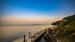 a dock with chairs and umbrellas on the water at Boutique & Design Hotel Navis - Small Luxury Hotels of the World in Opatija